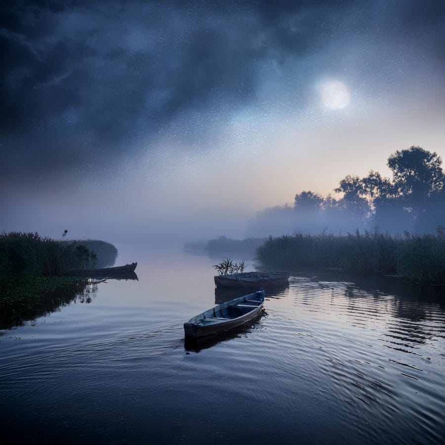 Firefly danube delta at night with fishing boats and dramatic clouds fog on the river romania2 235
