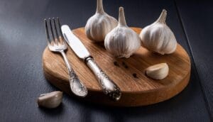 Firefly garlic on a cutting board with a knife and fork 28326