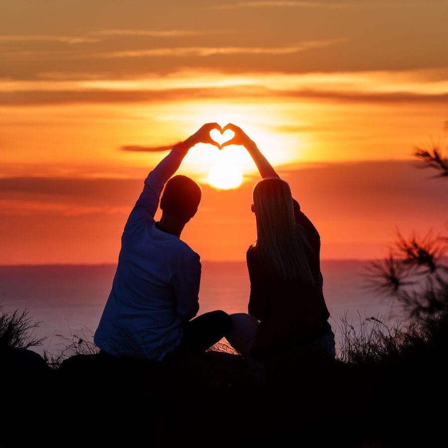 Firefly people in love watching the sunset and making heart shape 97585