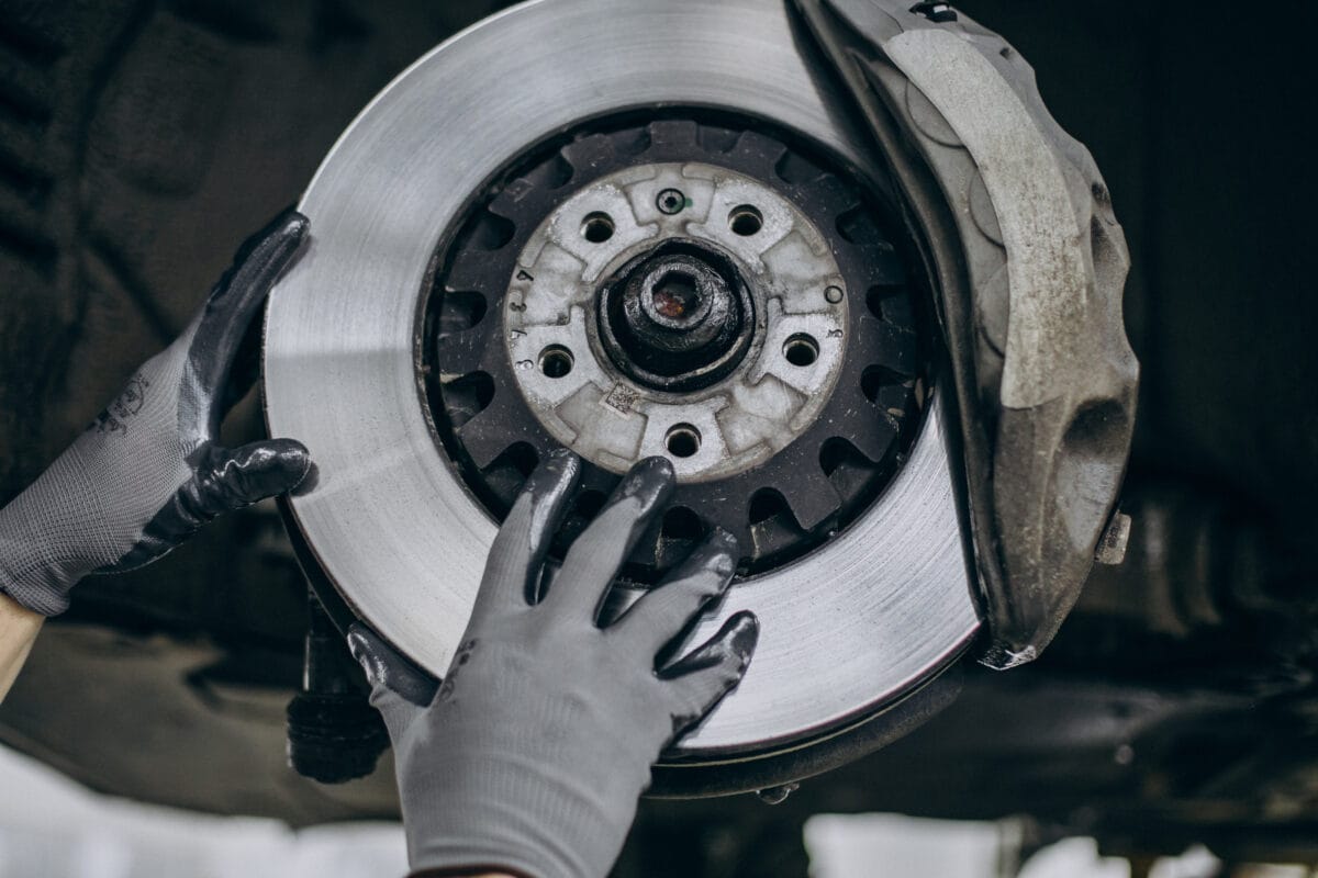 mechanic changing brake discs car service scaled e1755706180996